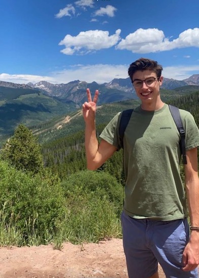 Henry Fox standing on top of mountain